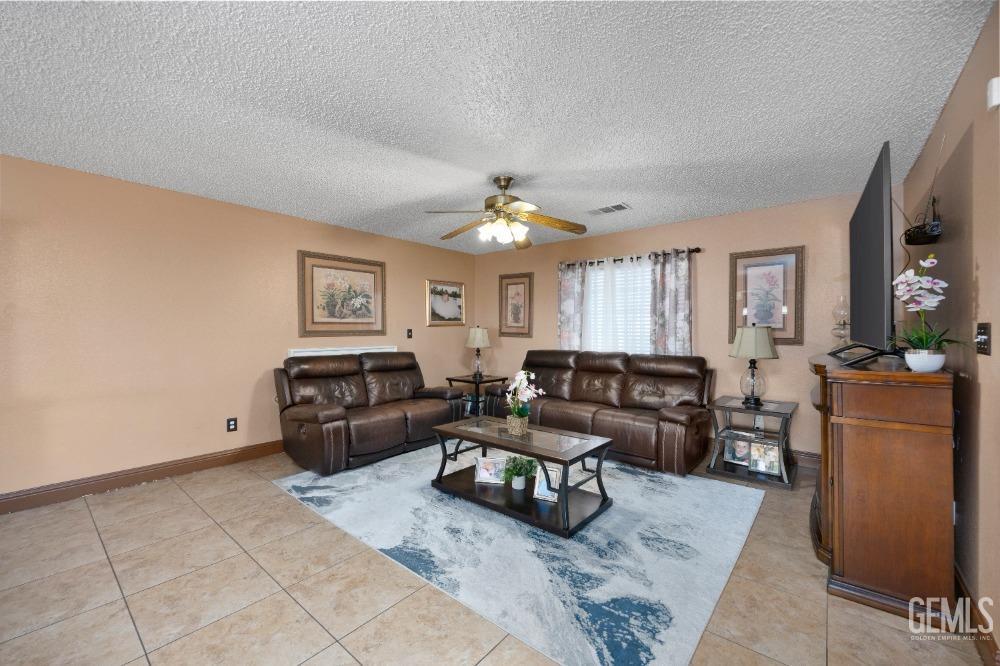 Undisclosed Address Shafter, CA 93263 - Photo 11 of 42 a living room with furniture and a chandelier
