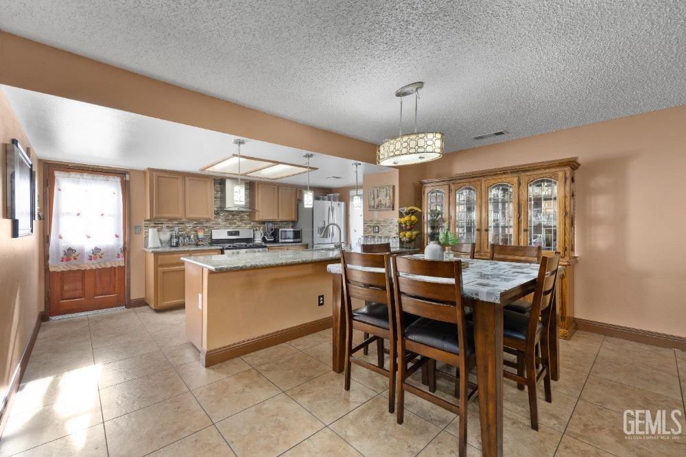 Undisclosed Address Shafter, CA 93263 - Photo 14 of 42 a kitchen with a table and chairs in it