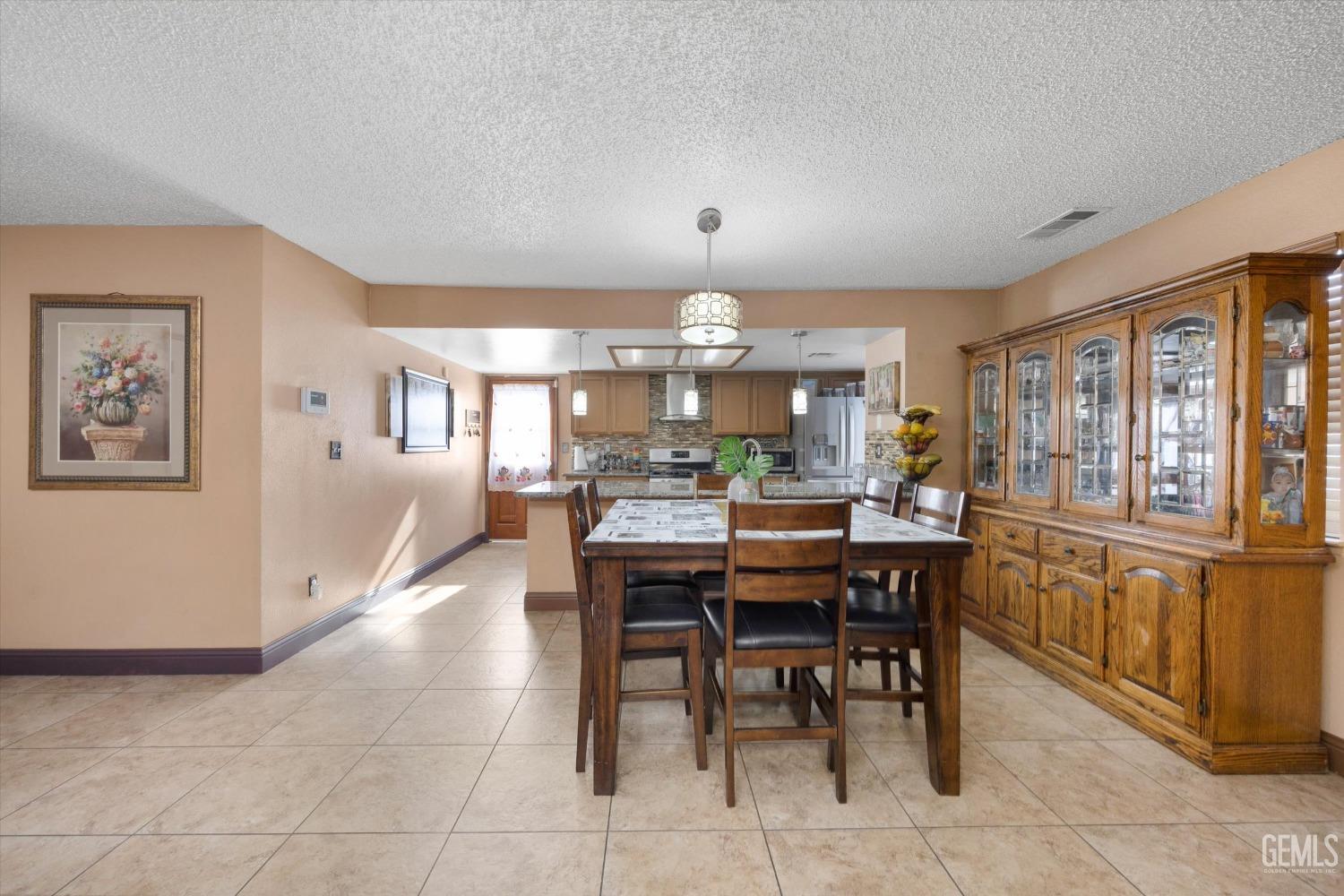 Undisclosed Address Shafter, CA 93263 - Photo 15 of 42 a view of a dining room with furniture window and wooden floor
