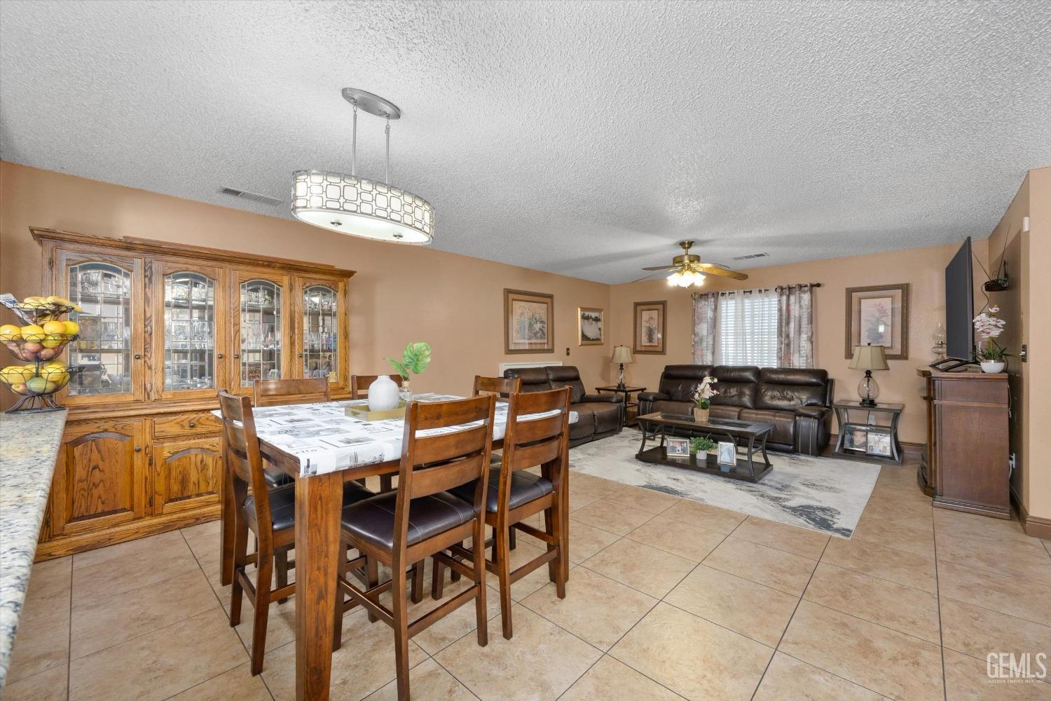 Undisclosed Address Shafter, CA 93263 - Photo 17 of 42 a view of a dining room with furniture and chandelier