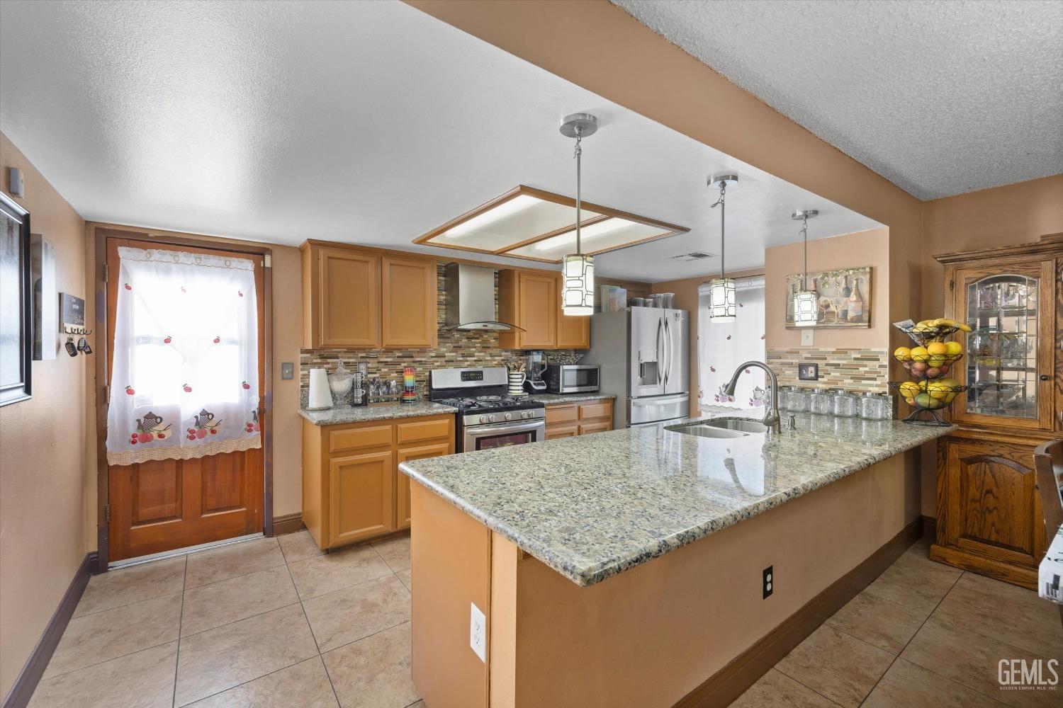 Undisclosed Address Shafter, CA 93263 - Photo 18 of 42 a kitchen with stainless steel appliances granite countertop a sink and cabinets
