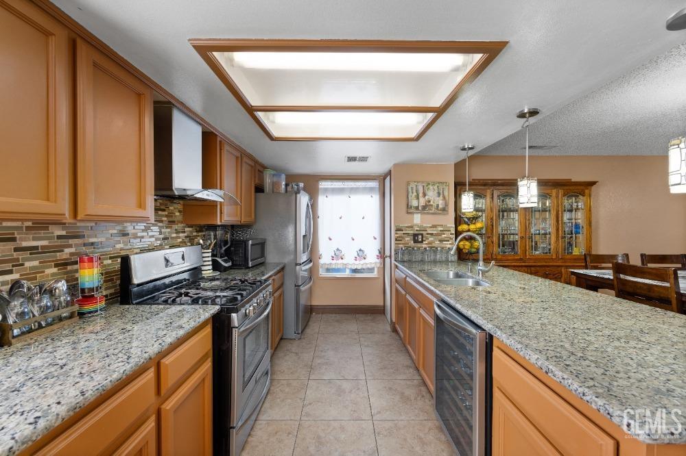 Undisclosed Address Shafter, CA 93263 - Photo 19 of 42 a large kitchen with stainless steel appliances granite countertop a stove and large sink