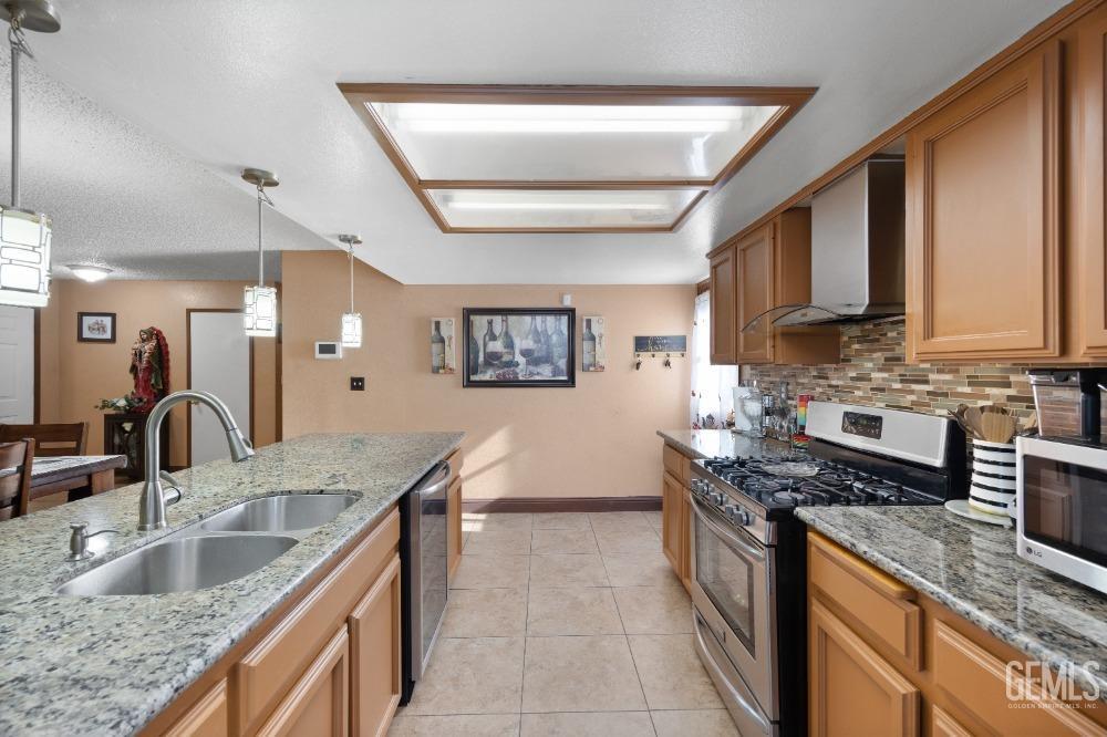 Undisclosed Address Shafter, CA 93263 - Photo 21 of 42 a kitchen with stainless steel appliances granite countertop a sink stove and cabinets