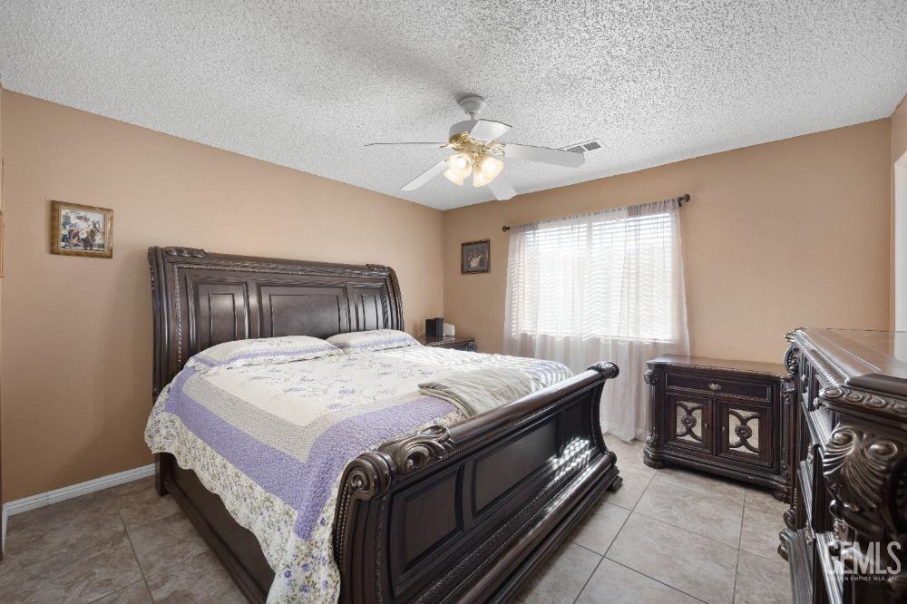 Undisclosed Address Shafter, CA 93263 - Photo 22 of 42 a bedroom with a bed and a chandelier