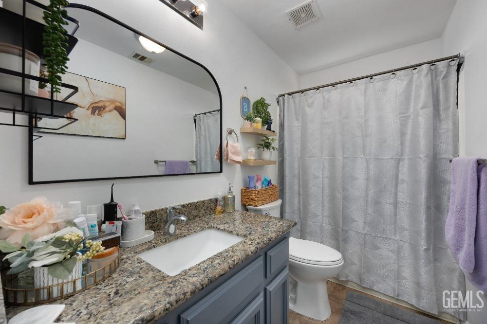 Undisclosed Address Shafter, CA 93263 - Photo 24 of 42 a bathroom with a granite countertop sink and a mirror with toilet