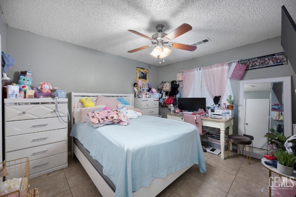 Undisclosed Address Shafter, CA 93263 - Photo 28 of 42 a bedroom with a bed and a chandelier