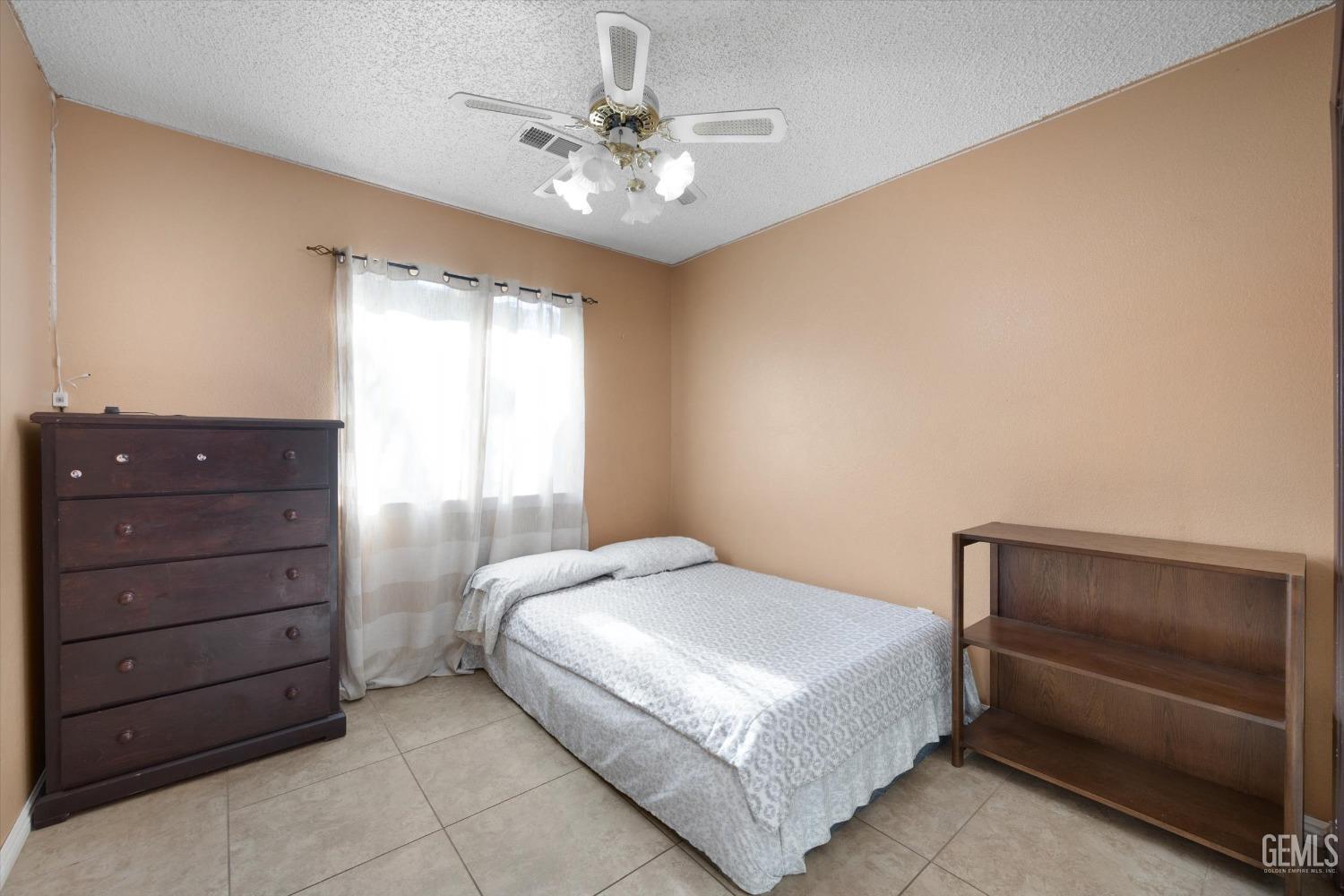 Undisclosed Address Shafter, CA 93263 - Photo 29 of 42 a bedroom with a bed and a dresser