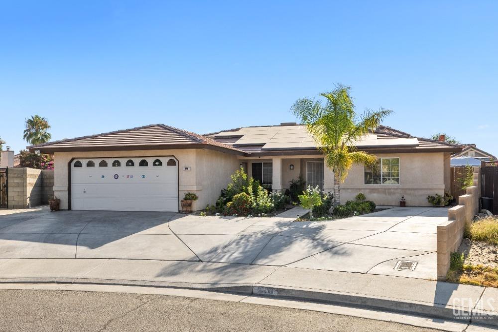 Undisclosed Address Shafter, CA 93263 - Photo 4 of 42 a front view of a house with a yard and garage
