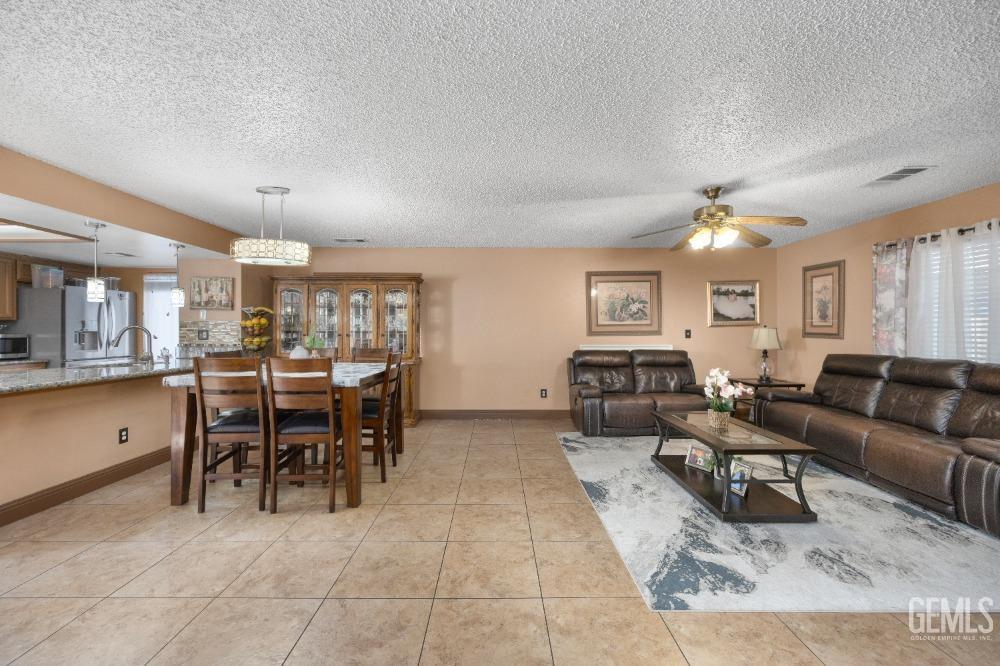 Undisclosed Address Shafter, CA 93263 - Photo 9 of 42 a living room with furniture a dining table and chairs