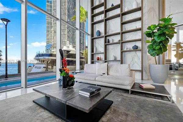 a living room with furniture and flowers