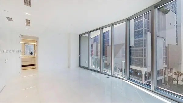 a view of a balcony with wooden floor and windows