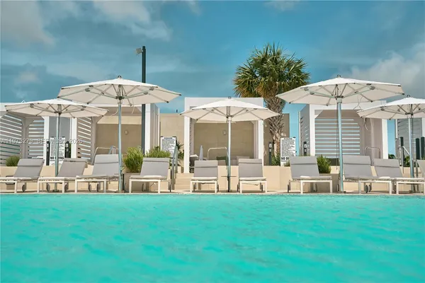 a swimming pool view with a outdoor seating