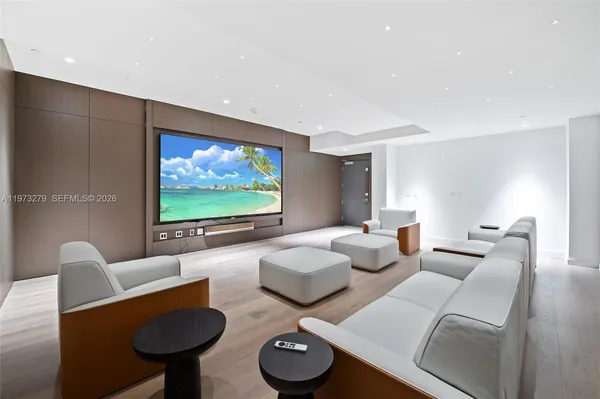 a media room with lots of chairs and a projector screen