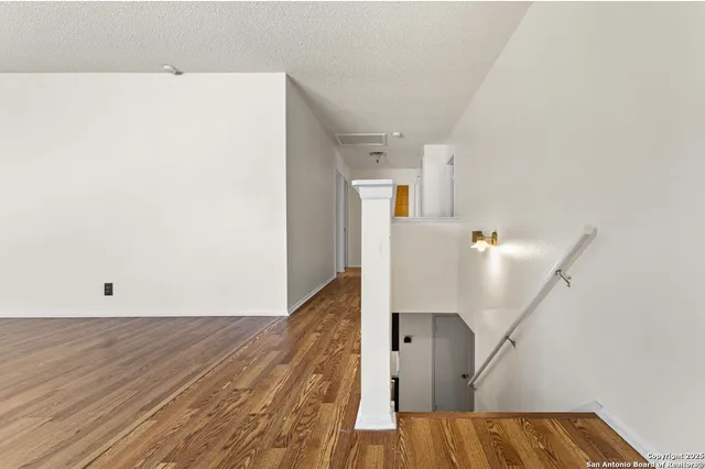 a view of a room with wooden floor and staircase