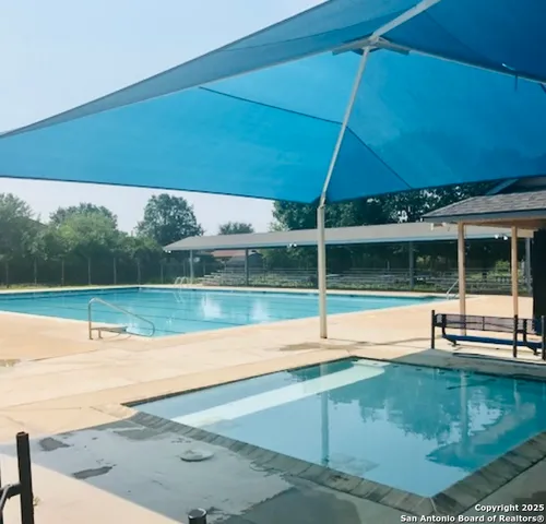 a view of a swimming pool with a yard