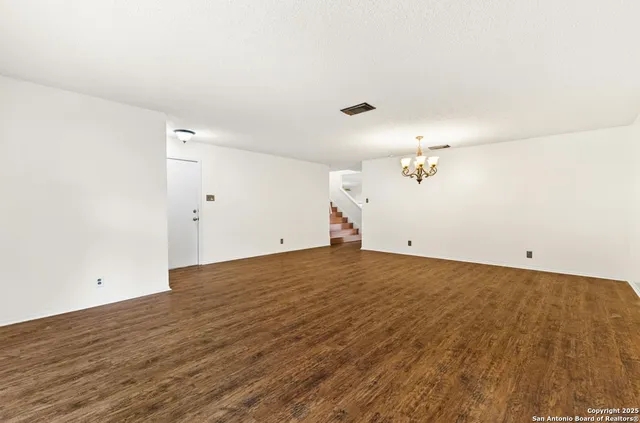 a view of a room with wooden floor