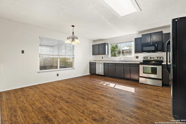 a large kitchen with cabinets and stainless steel appliances