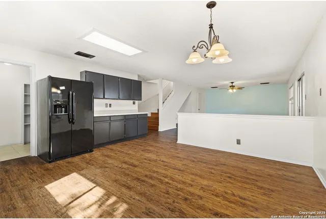 a view of a kitchen with a sink and refrigerator