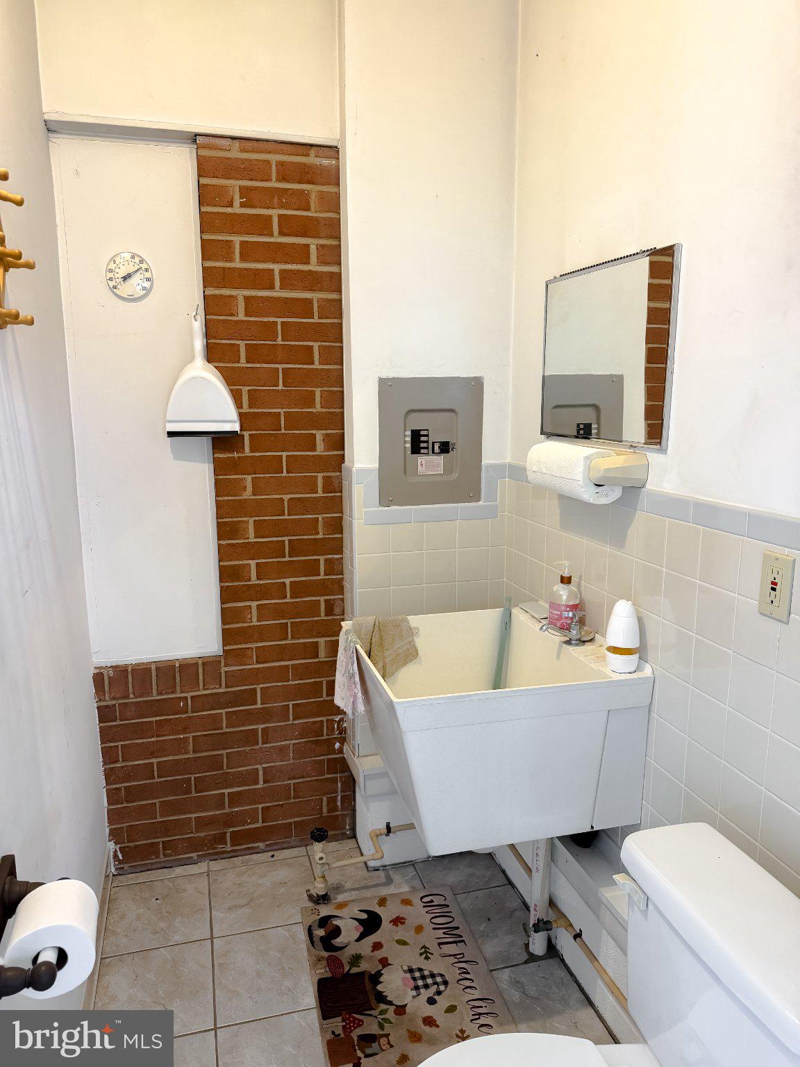 23230 Colton Point Road Avenue, MD 20609 - Photo 56 of 63 Charming bathroom with unique brick accent.
