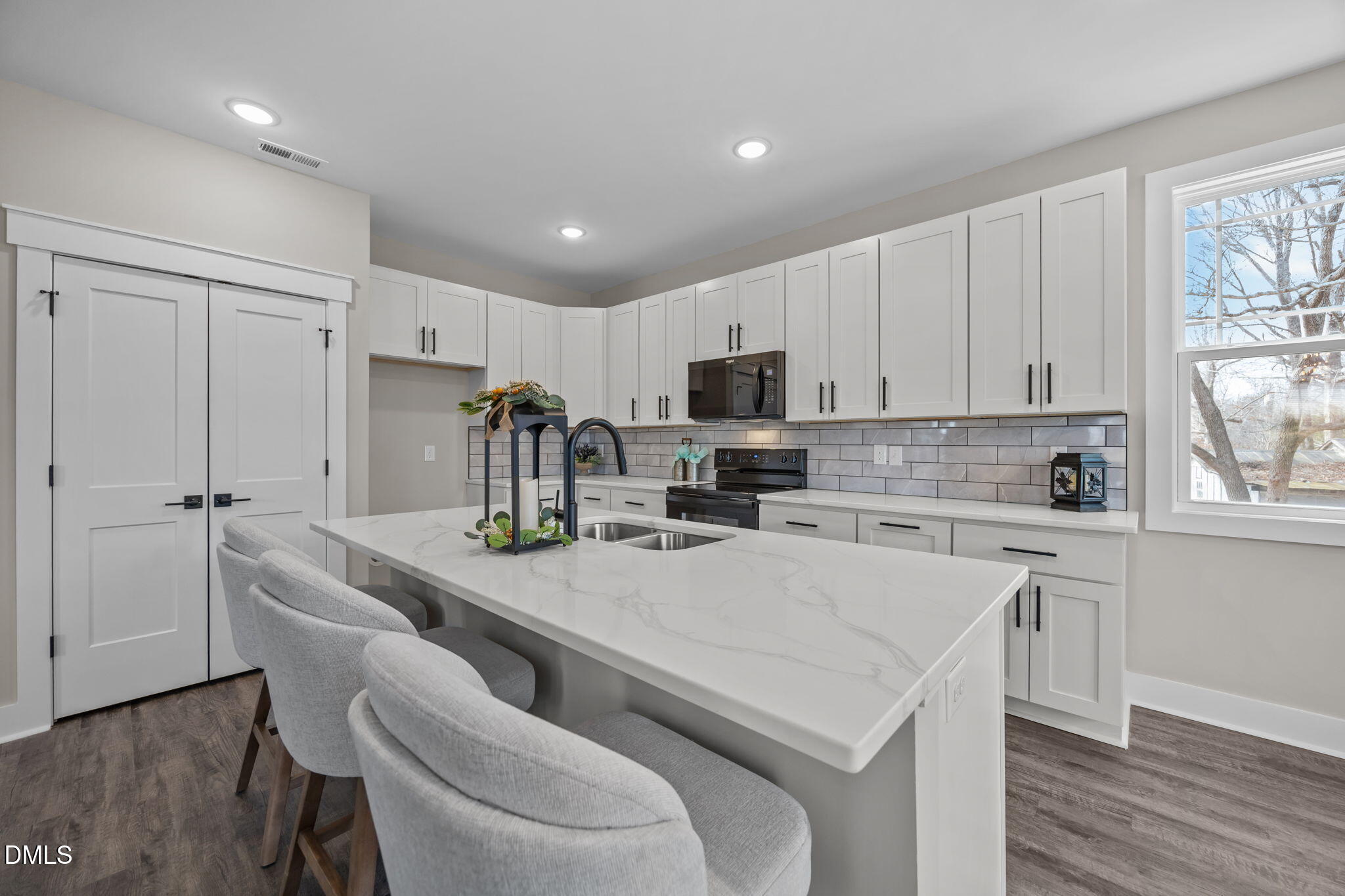 3917 Highway 42 Raleigh, NC 27603 - Photo 10 of 46 a kitchen with white cabinets and stainless steel appliances