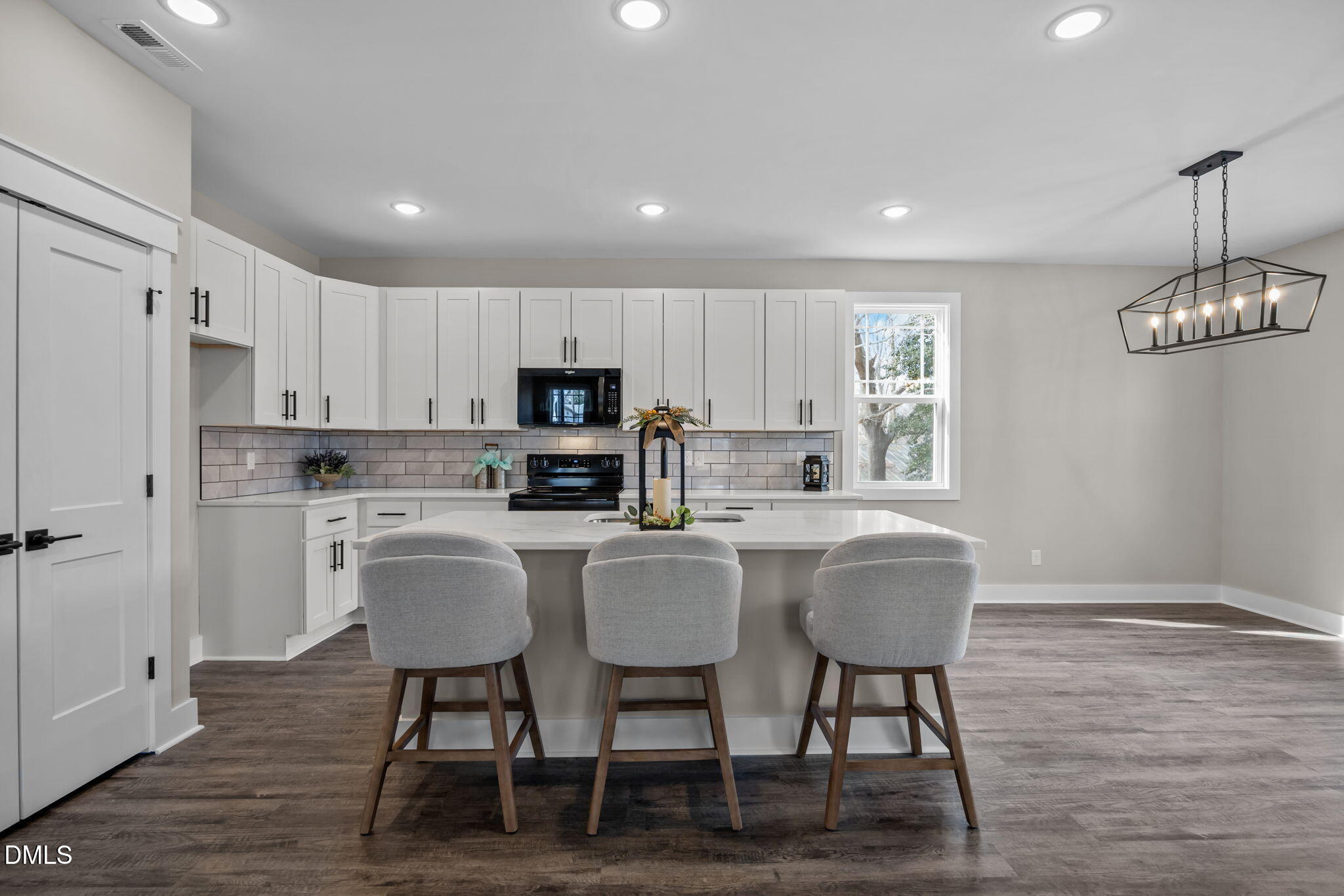 3917 Highway 42 Raleigh, NC 27603 - Photo 11 of 46 a kitchen with stainless steel appliances granite countertop a dining table chairs refrigerator and cabinets