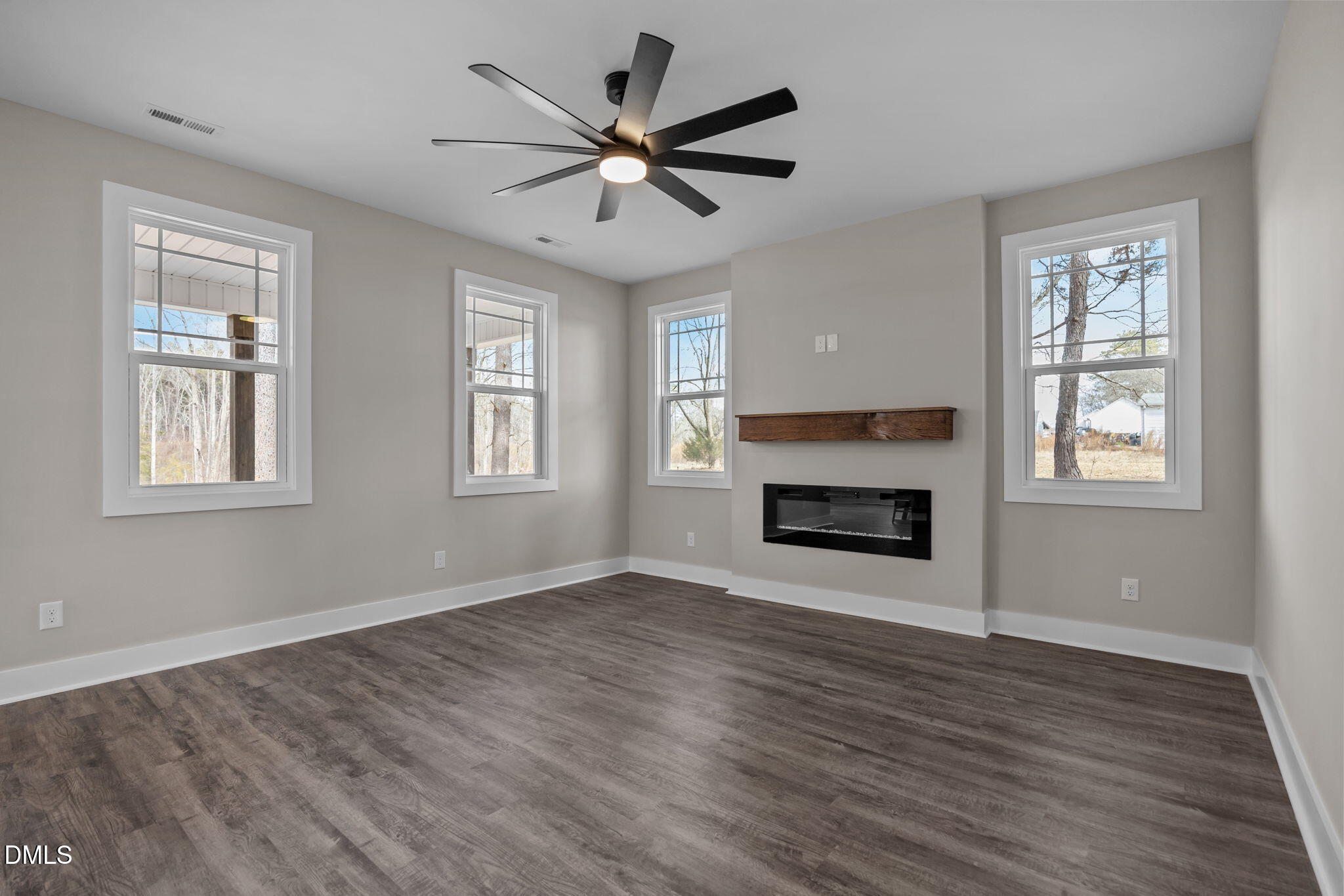 3917 Highway 42 Raleigh, NC 27603 - Photo 13 of 46 a view of an empty room with wooden floor and a window