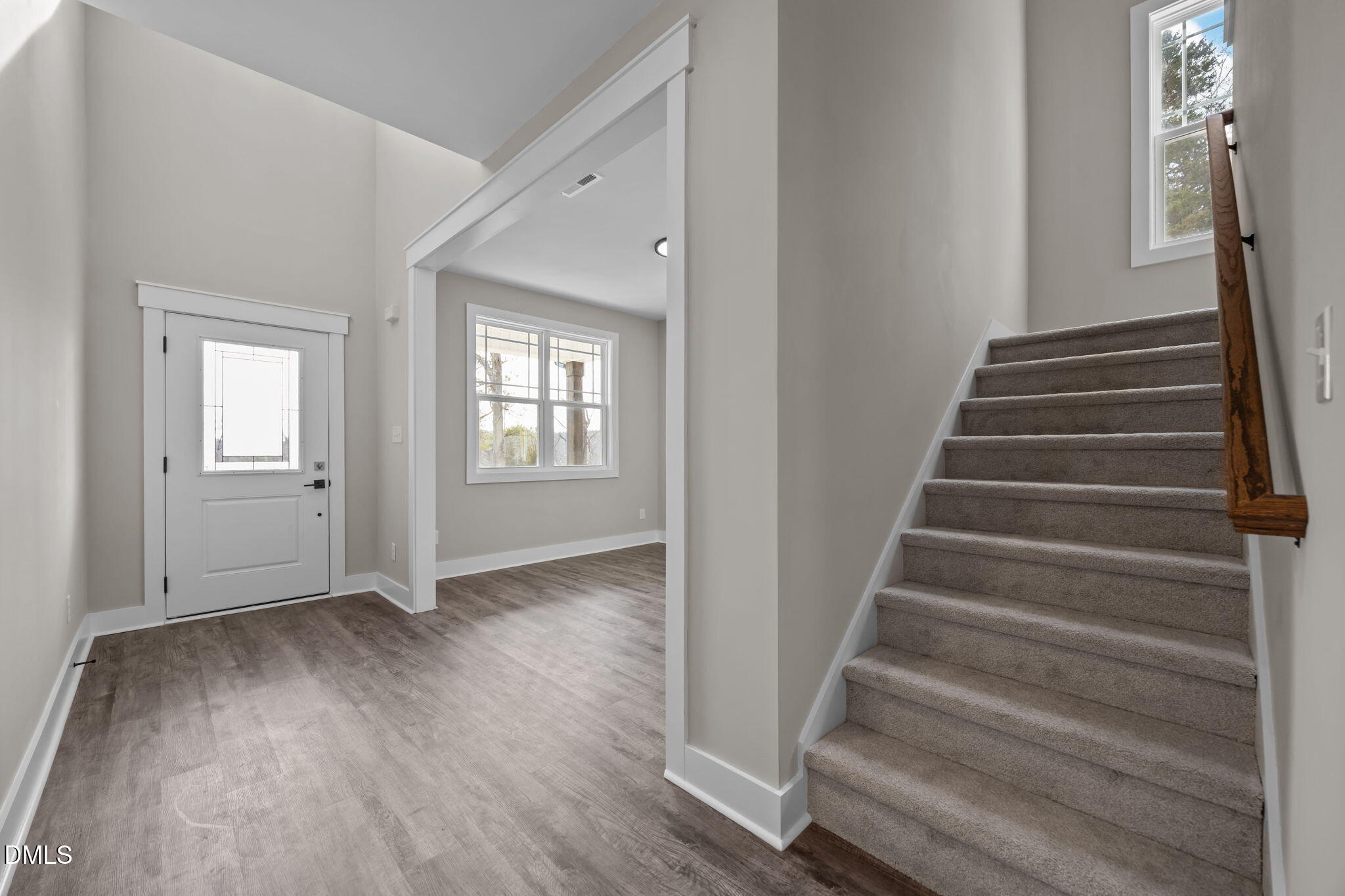 3917 Highway 42 Raleigh, NC 27603 - Photo 15 of 46 a view of an entryway with wooden floor and stairs