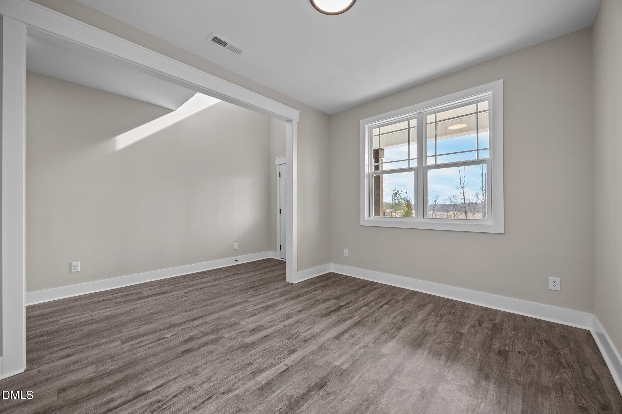 3917 Highway 42 Raleigh, NC 27603 - Photo 19 of 46 a view of an empty room with wooden floor and a window