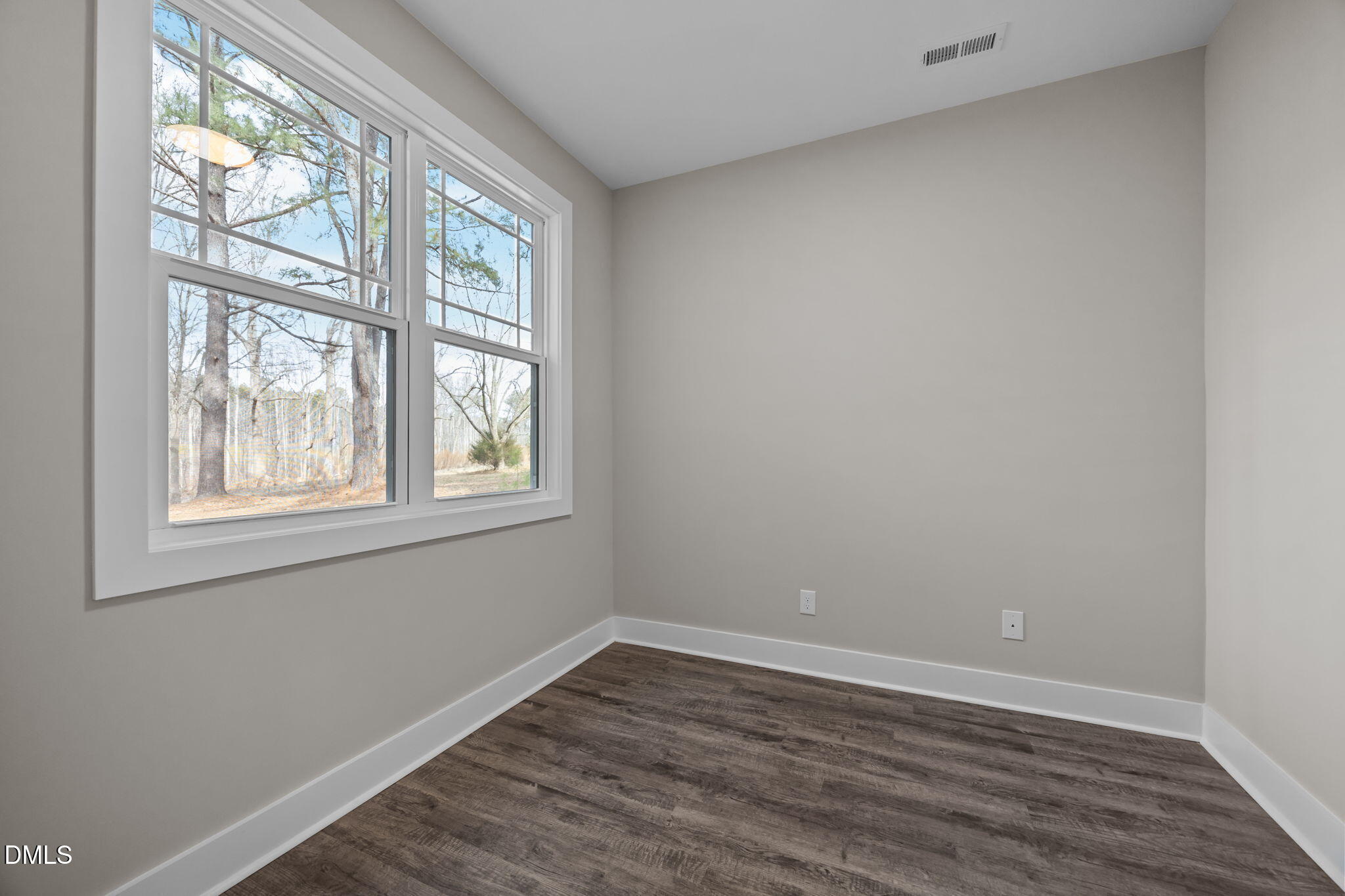 3917 Highway 42 Raleigh, NC 27603 - Photo 20 of 46 an empty room with wooden floor and windows