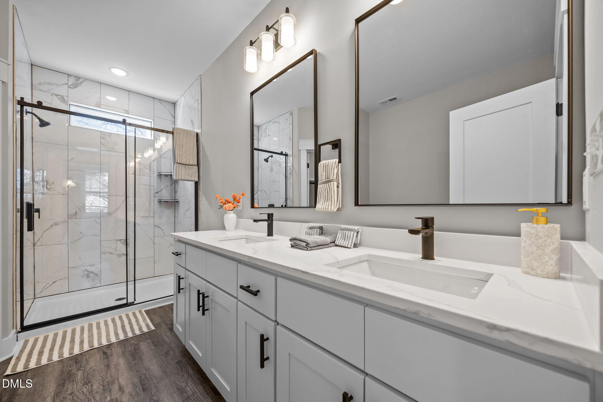 3917 Highway 42 Raleigh, NC 27603 - Photo 31 of 46 a bathroom with a double vanity sink mirror double shower and a mirror