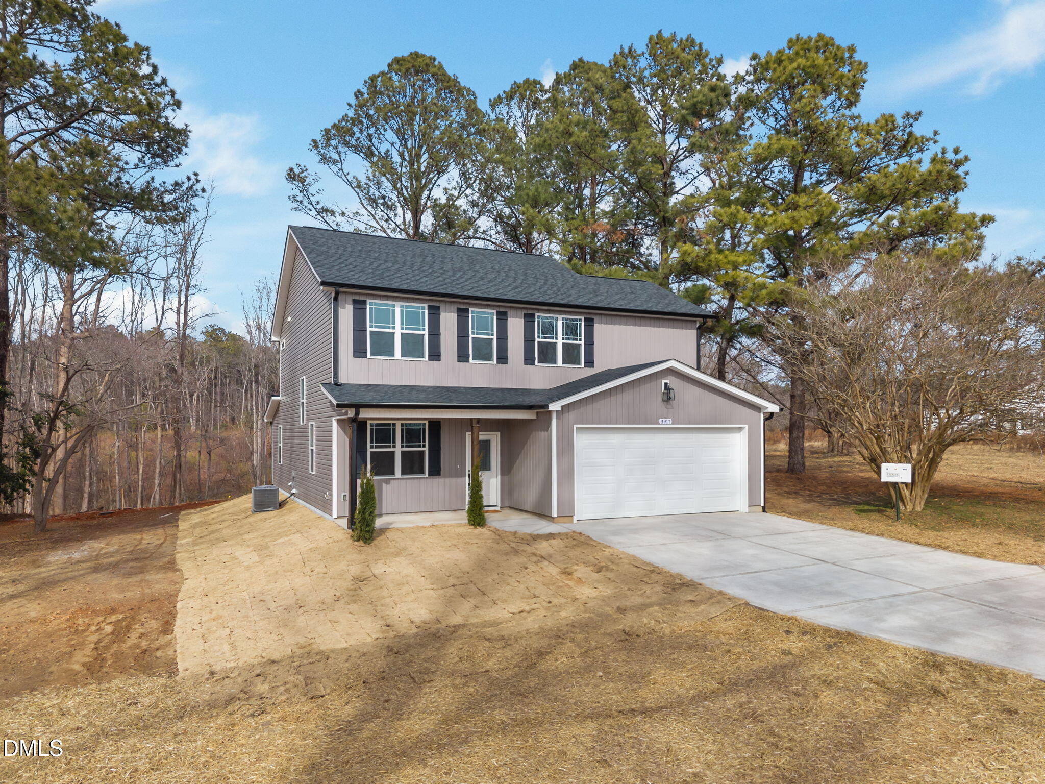 3917 Highway 42 Raleigh, NC 27603 - Photo 3 of 46 a front view of a house with a yard and garage