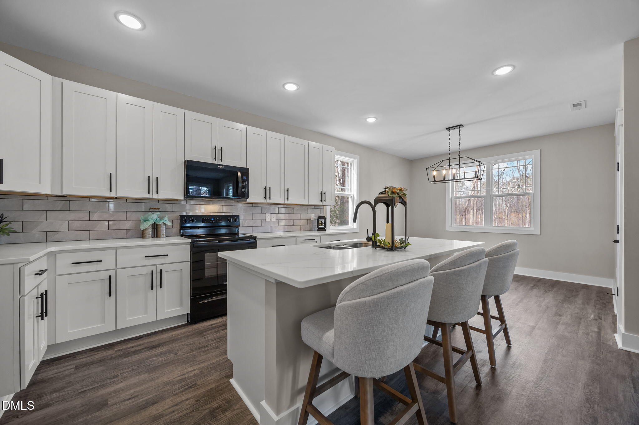 3917 Highway 42 Raleigh, NC 27603 - Photo 5 of 46 a kitchen with stainless steel appliances granite countertop a table chairs sink refrigerator and cabinets