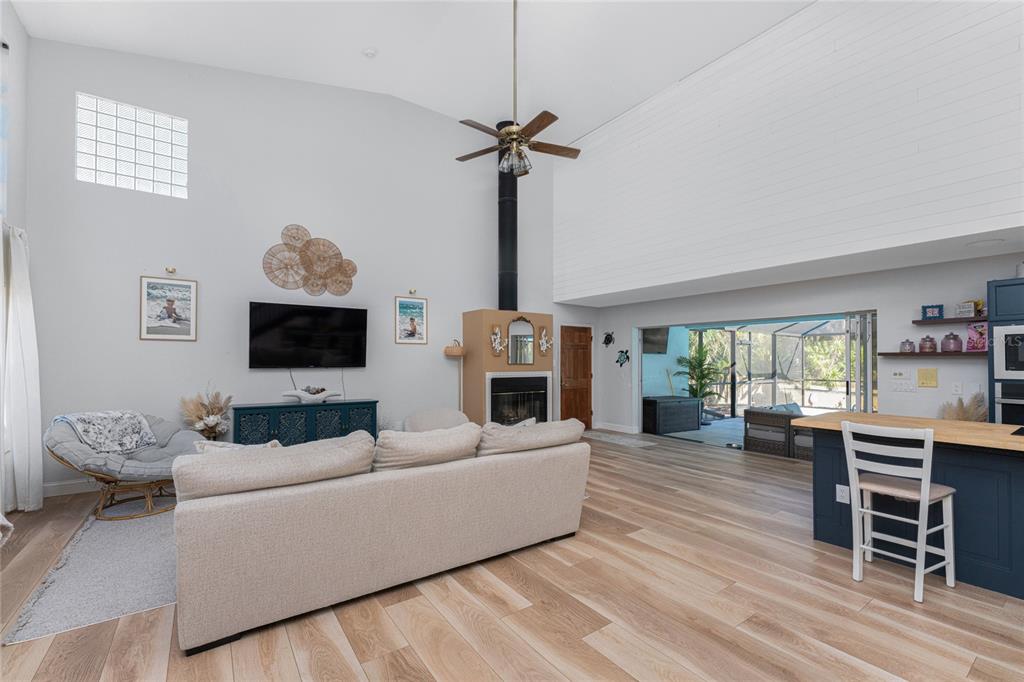 196 Lecturn Street Port Charlotte, FL 33954 - Photo 15 of 72 a living room with furniture a flat screen tv and a fireplace