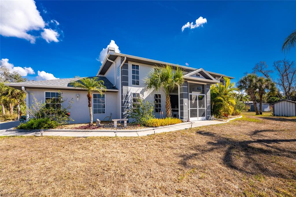 196 Lecturn Street Port Charlotte, FL 33954 - Photo 2 of 72 a front view of a house with a yard