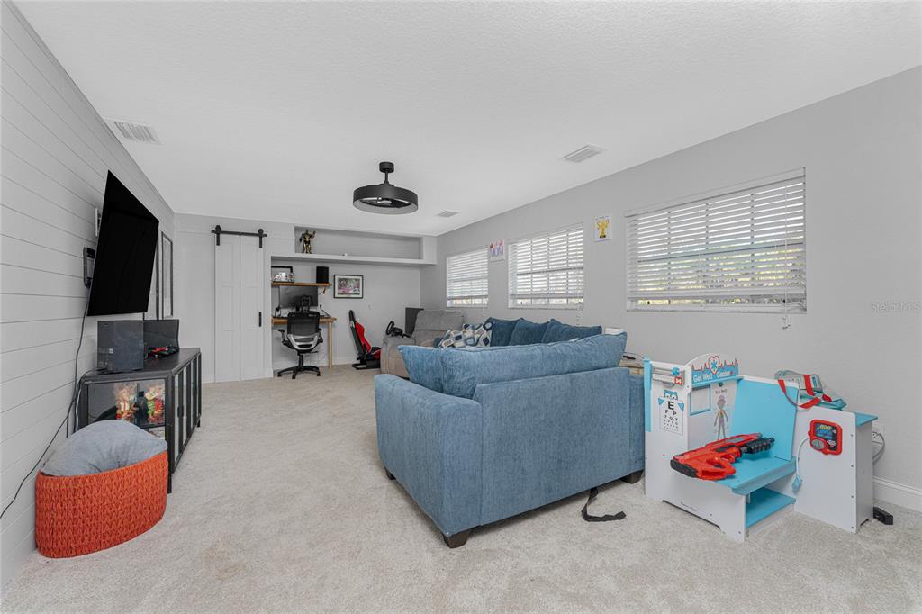 196 Lecturn Street Port Charlotte, FL 33954 - Photo 22 of 72 a living room with furniture and a flat screen tv