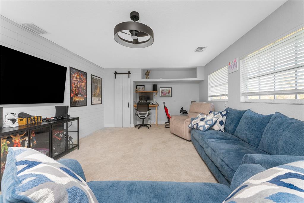 196 Lecturn Street Port Charlotte, FL 33954 - Photo 25 of 72 a living room with furniture and a flat screen tv