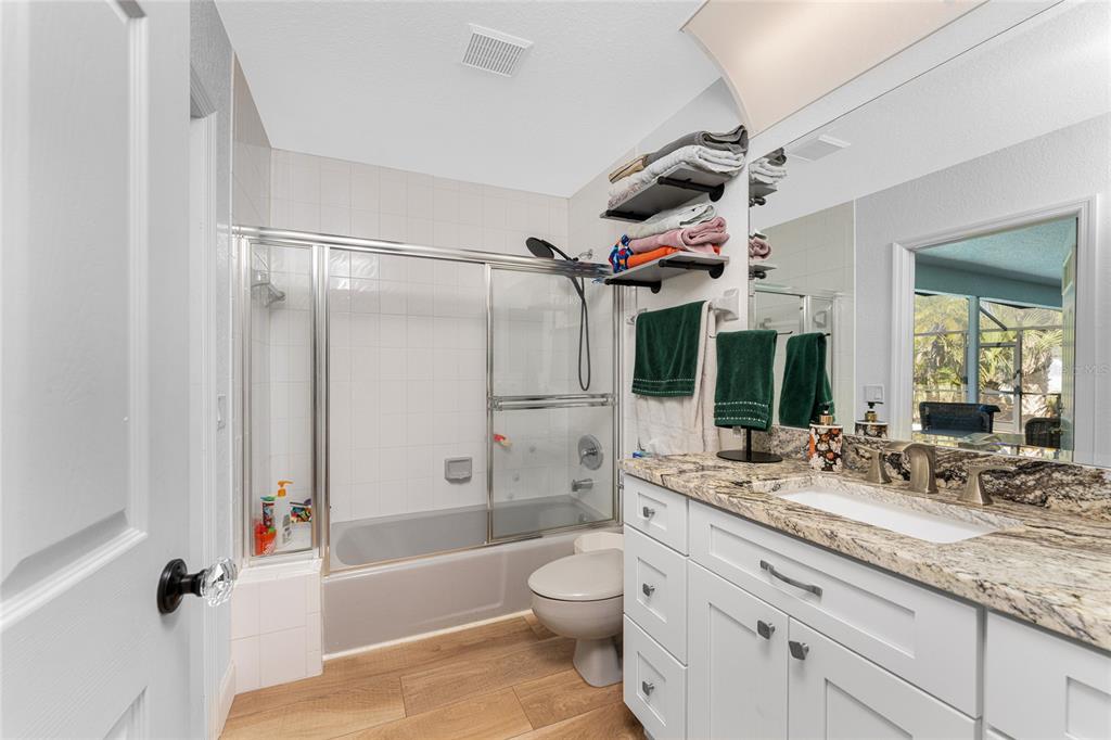 196 Lecturn Street Port Charlotte, FL 33954 - Photo 39 of 72 a bathroom with a granite countertop sink toilet and shower