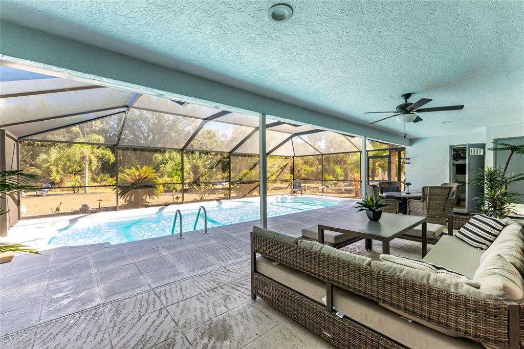 196 Lecturn Street Port Charlotte, FL 33954 - Photo 41 of 72 a living room with furniture and a large window