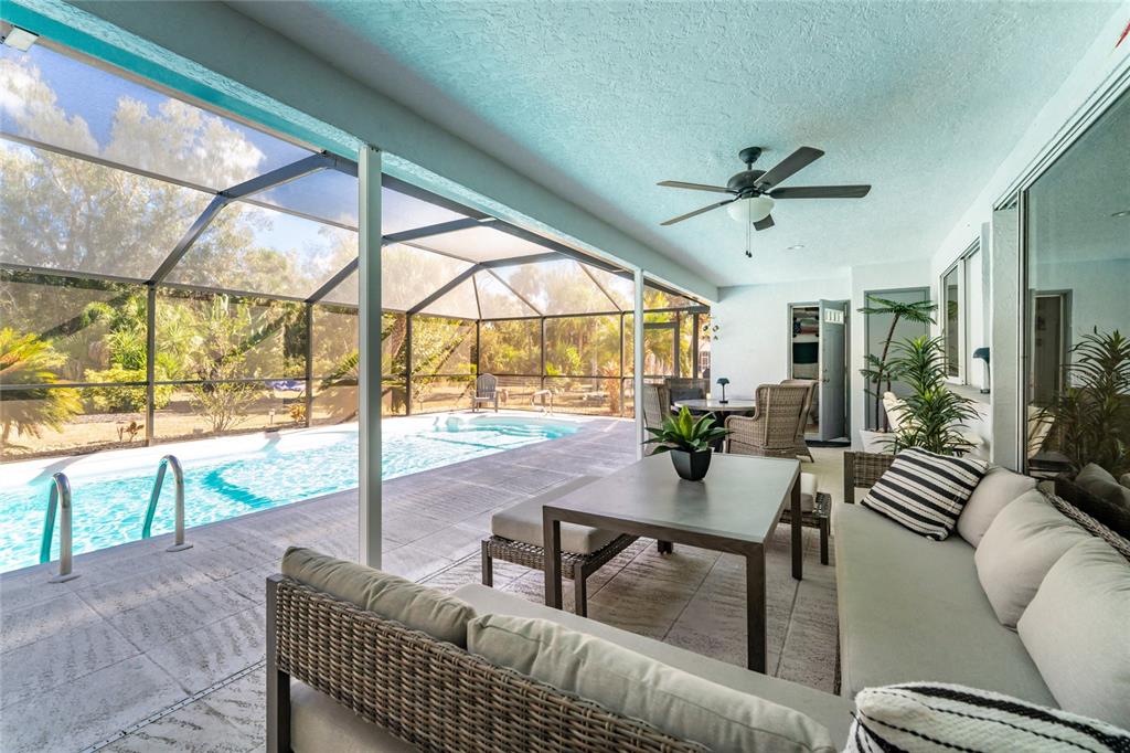 196 Lecturn Street Port Charlotte, FL 33954 - Photo 42 of 72 a living room with furniture and a floor to ceiling window