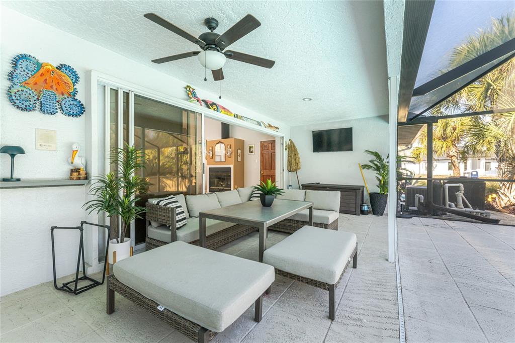 196 Lecturn Street Port Charlotte, FL 33954 - Photo 45 of 72 a living room with furniture a chandelier and a floor to ceiling window