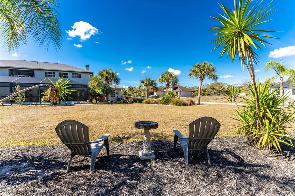 196 Lecturn Street Port Charlotte, FL 33954 - Photo 52 of 72 a view of a swimming pool with a table and chairs