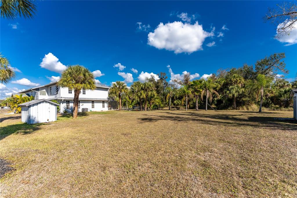 196 Lecturn Street Port Charlotte, FL 33954 - Photo 58 of 72 a view of a fountain in front of a house with a yard
