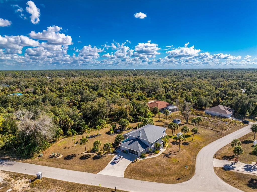 196 Lecturn Street Port Charlotte, FL 33954 - Photo 63 of 72 a view of a dining room with furniture a chandelier and large mirror