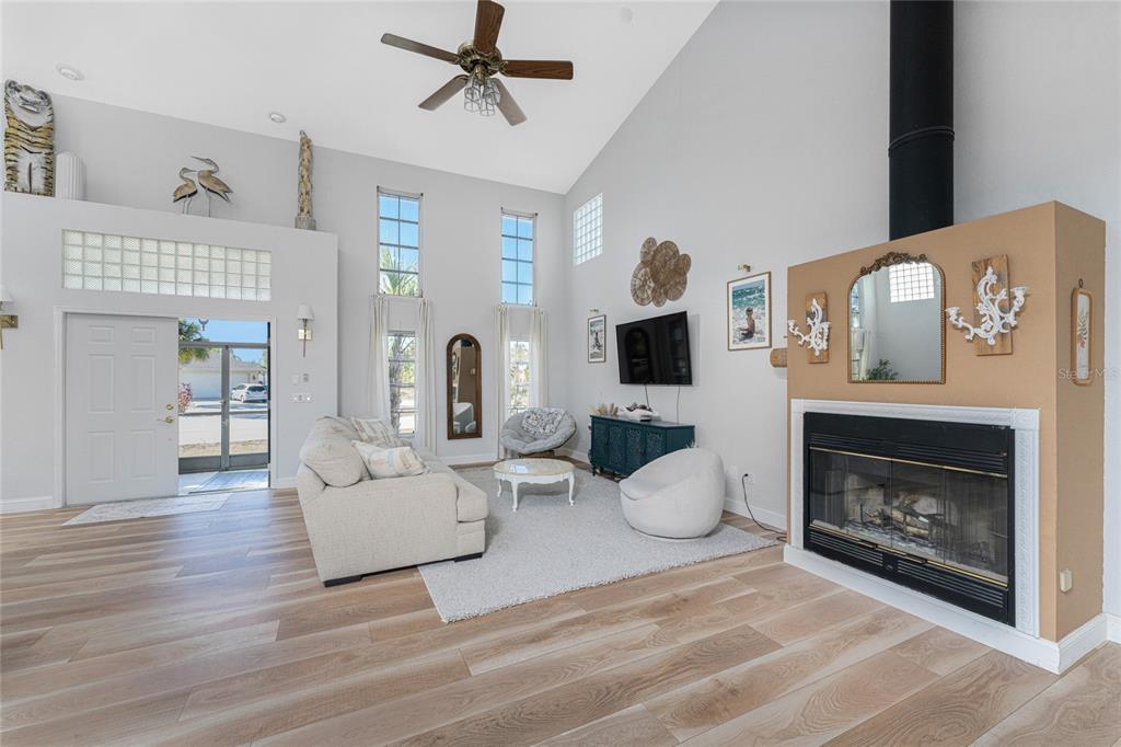 196 Lecturn Street Port Charlotte, FL 33954 - Photo 8 of 72 a living room with furniture a flat screen tv and a fireplace