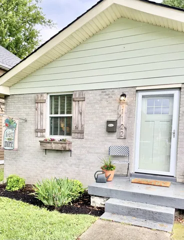 a view of a patio with table and chairs and potted plants