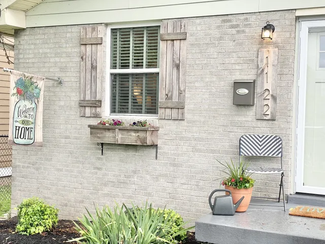 a front view of a house with outdoor seating
