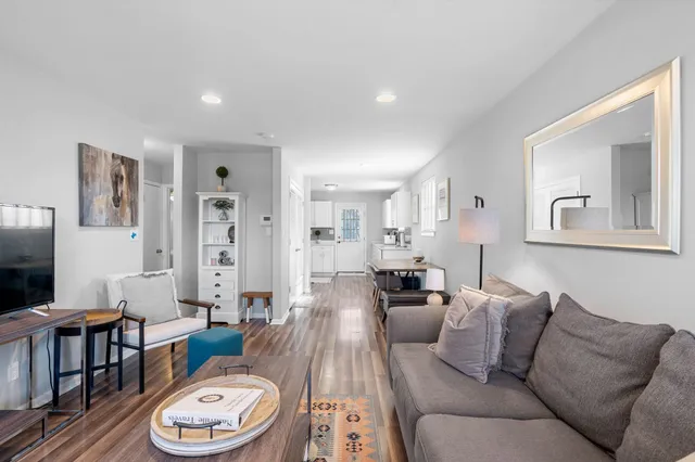 a living room with furniture a couch and a flat screen tv