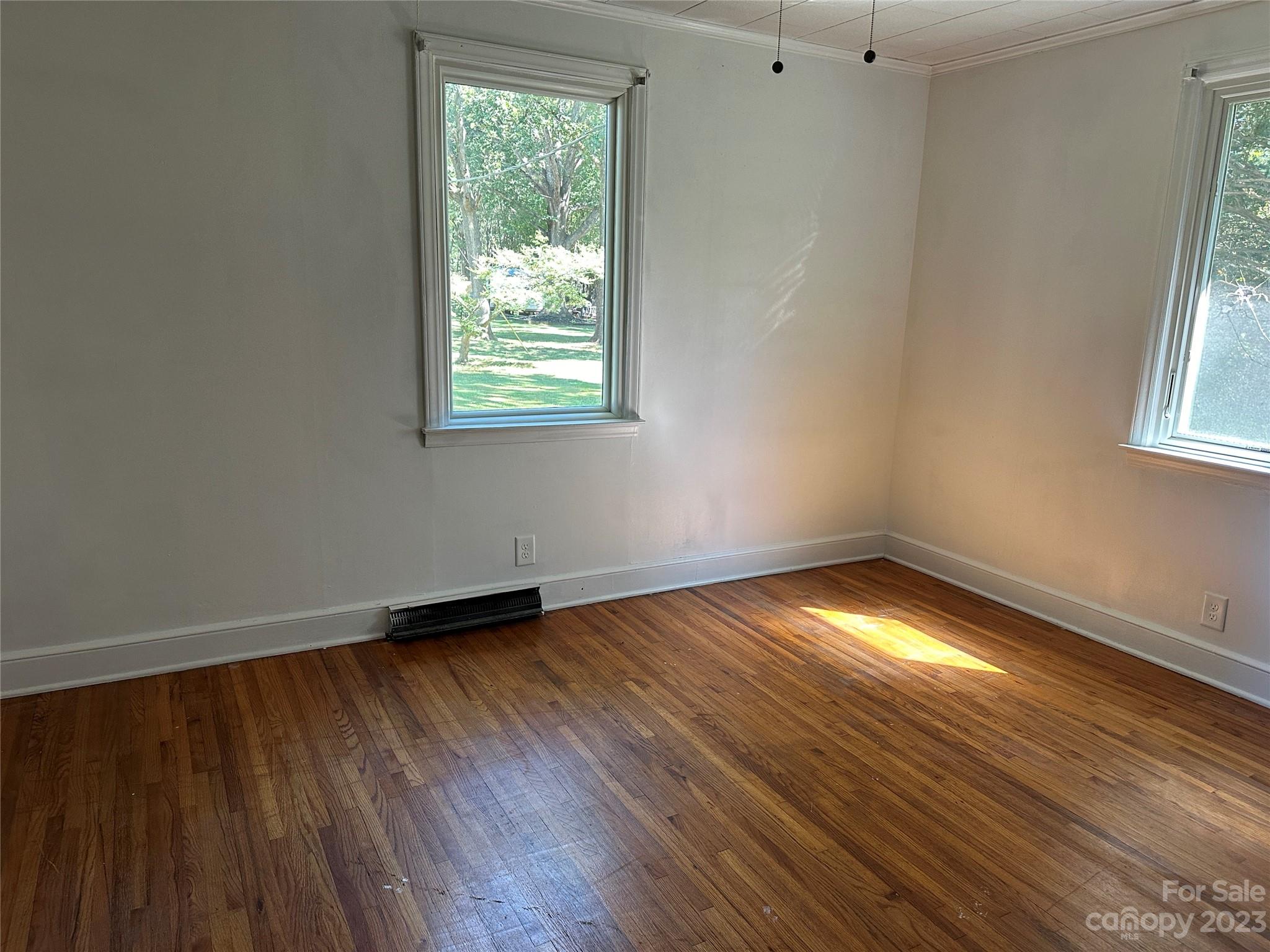 4205 Titman Road Gastonia, NC 28056 - Photo 11 of 16 an empty room with wooden floor and windows