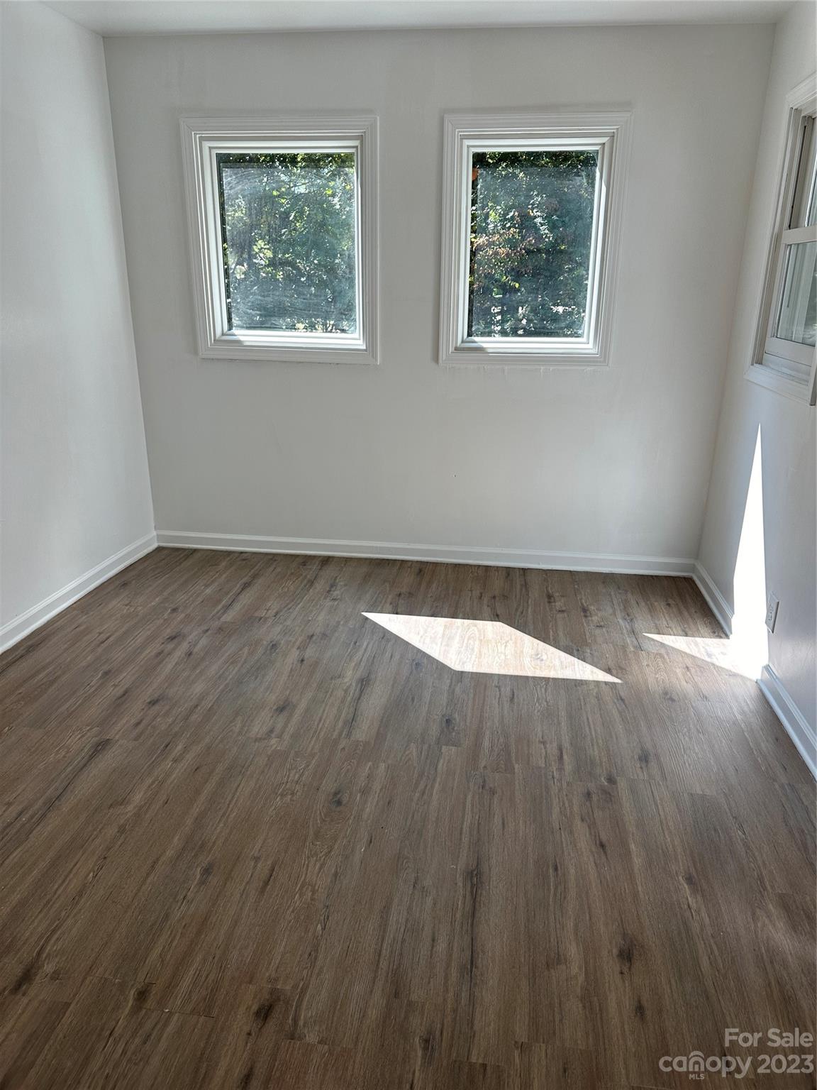 4205 Titman Road Gastonia, NC 28056 - Photo 4 of 16 a view of an empty room with wooden floor and a window