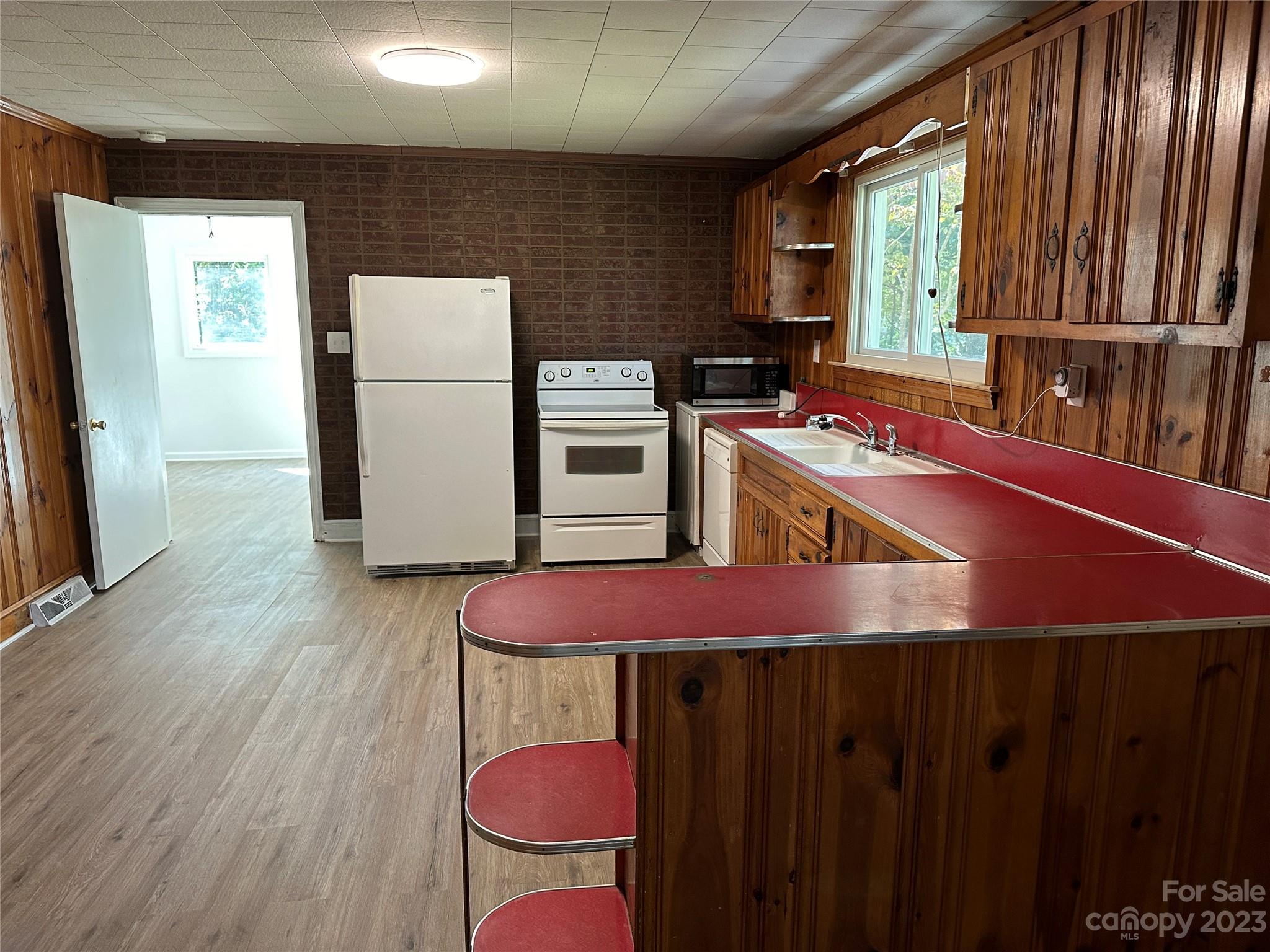 4205 Titman Road Gastonia, NC 28056 - Photo 8 of 16 a kitchen with wooden cabinets a stove and a refrigerator